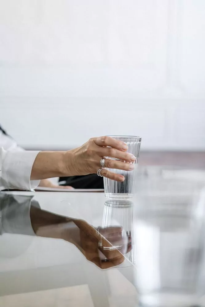 Person in White Dress Shirt Holding Clear Drinking Glass